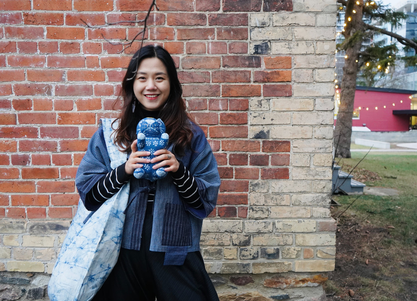 Model with Ice Crack Shoulder Bag and Batik Doll