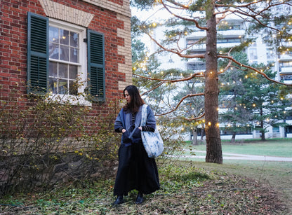 Model standing in front of a heritage building and lights