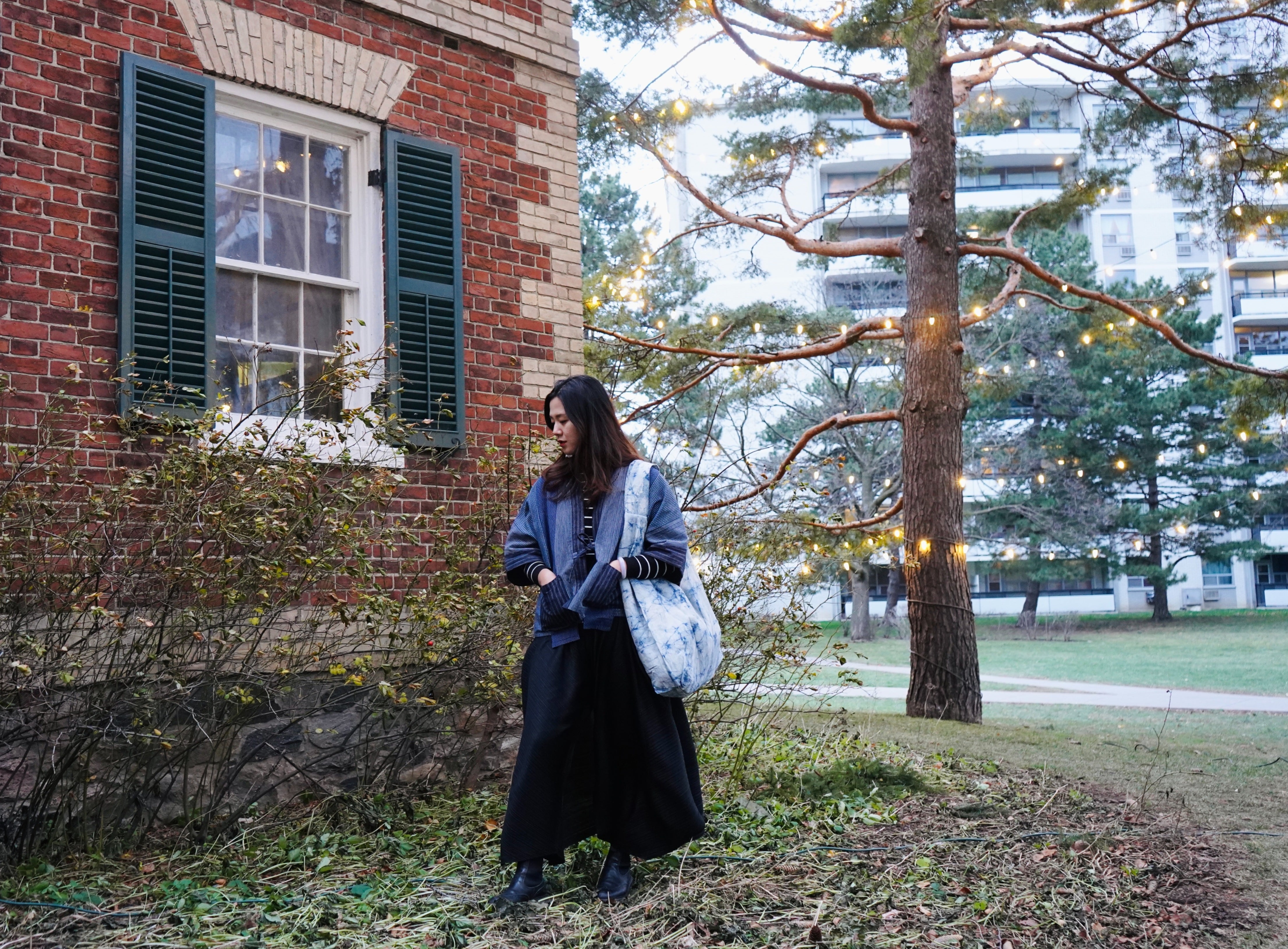 Model standing in front of a heritage building and lights